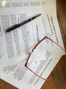 last will and testament papers with pen and eyesglasses